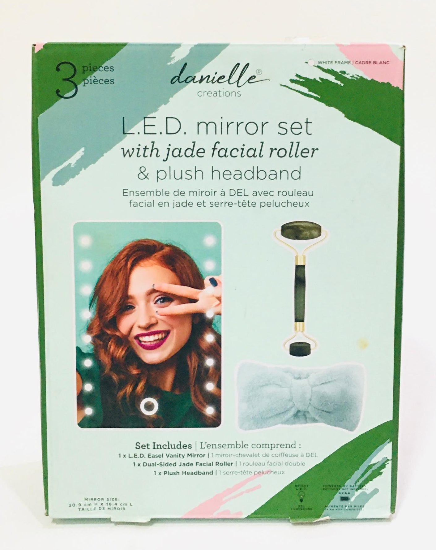 Danielle Creations L.E.D. mirror set, which includes an illuminating vanity mirror, a dual-sided jade facial roller, and a plush headband.