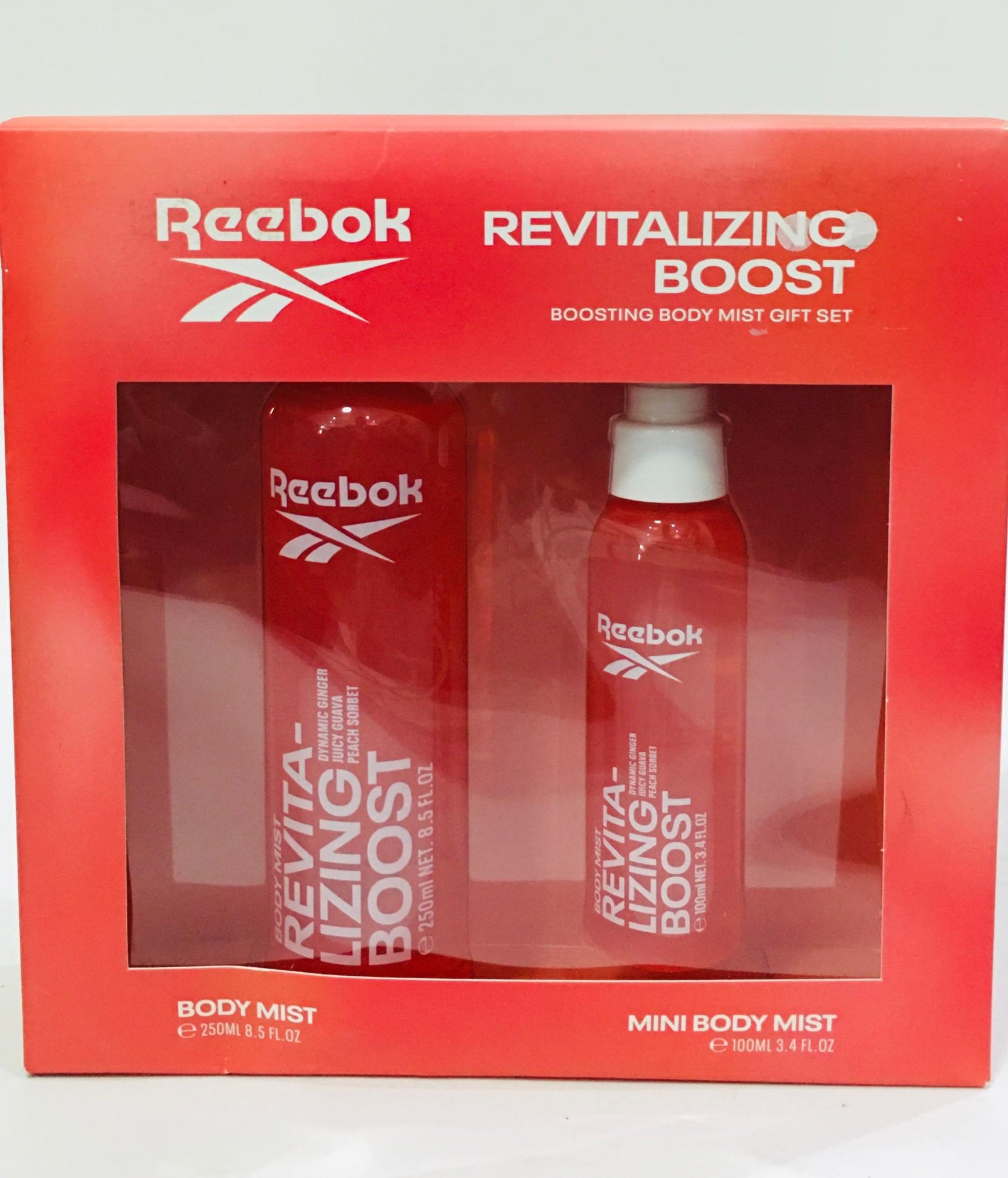Reebok Revitalizing Boost Body Mist Gift Set includes a full-size 250ml spray and a 100ml mini spray featuring a fruity fragrance with notes of ginger, guava, and peach
