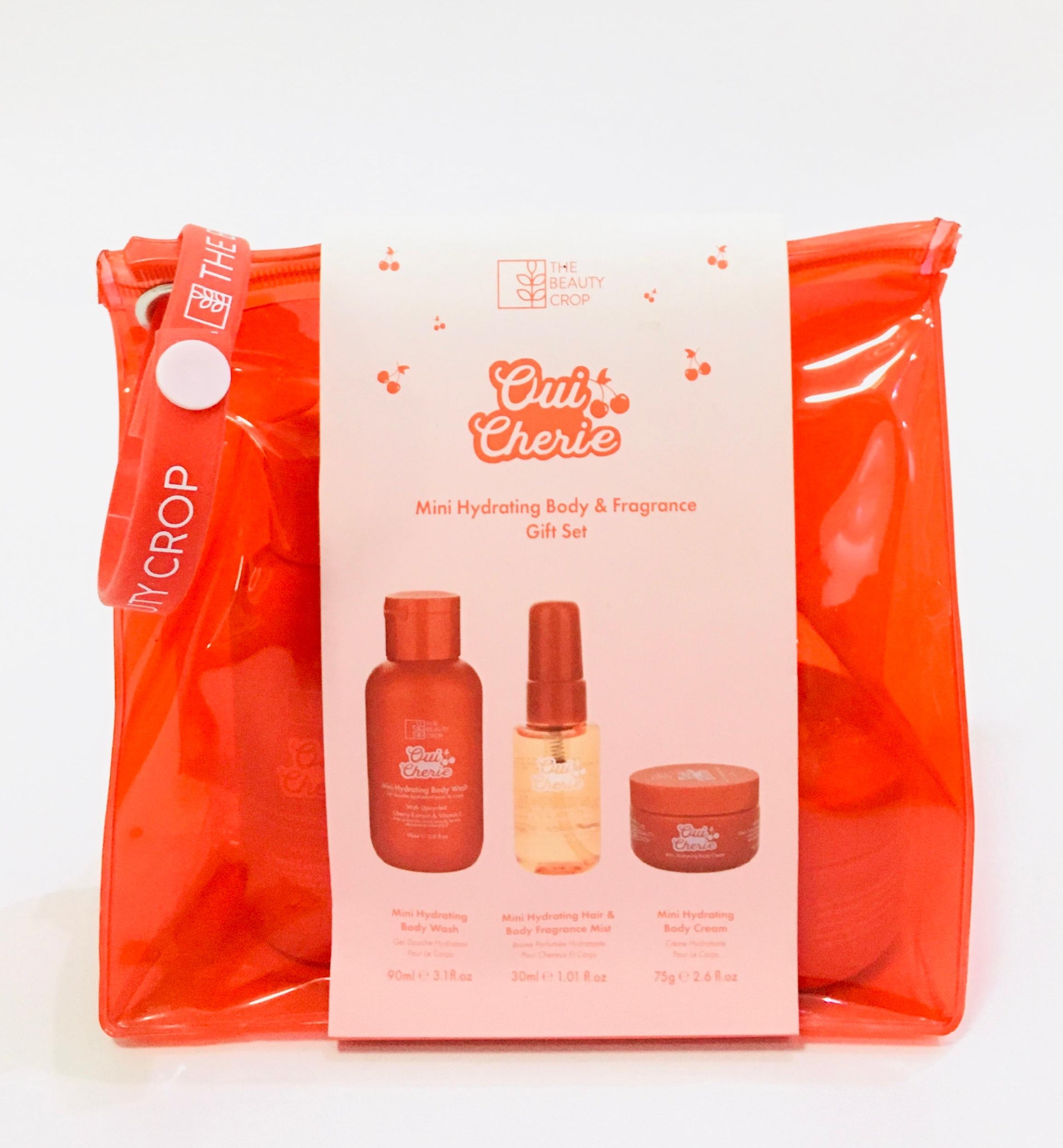 The Beauty Crop Oui Cherie Mini Hydrating Body & Fragrance Gift Set, a three-piece set featuring a mini body wash, hair and body mist, and body cream